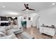 Open-concept living room with hardwood floors, a sectional sofa, and a view of the kitchen at 112 Aspire Cir, Wingate, NC 28174