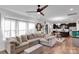 Spacious living area with a sectional sofa, hardwood floors, and an open layout to the kitchen at 112 Aspire Cir, Wingate, NC 28174