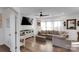 Bright living room features hardwood floors, a comfortable sofa, and a modern ceiling fan at 112 Aspire Cir, Wingate, NC 28174