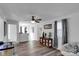 Bright, open living room with a ceiling fan, wood-look floors and a cabinet at 112 Aspire Cir, Wingate, NC 28174