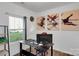 Bright office space with a desk, artwork, and large window providing natural light at 112 Aspire Cir, Wingate, NC 28174