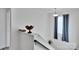 Well-lit upstairs hallway with a window and decorative items atop the wainscotting at 112 Aspire Cir, Wingate, NC 28174