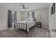 Charming bedroom with iron frame bed, plush carpeting, and plenty of natural light at 113 Ervin St, Belmont, NC 28012