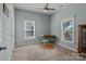 Relaxing bedroom featuring two windows, carpeted floors, and a desk area at 113 Ervin St, Belmont, NC 28012