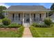 Charming home featuring a covered front porch, manicured lawn, and inviting curb appeal at 113 Ervin St, Belmont, NC 28012