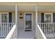 Inviting front porch with a rocking chair, black shutters, and a decorative door wreath at 113 Ervin St, Belmont, NC 28012
