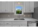 Bright kitchen featuring stainless steel appliances, grey backsplash, and a view from over the sink at 113 Ervin St, Belmont, NC 28012