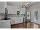 Bright kitchen featuring stainless steel appliances, white cabinets, and hardwood floors at 113 Ervin St, Belmont, NC 28012