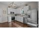 Modern kitchen features stainless steel appliances, white cabinets, and stylish backsplash at 113 Ervin St, Belmont, NC 28012