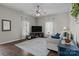Bright living room features wood floors, ceiling fan, neutral colors and modern furnishings at 113 Ervin St, Belmont, NC 28012