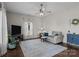 Cozy living room with natural light, ceiling fan, area rug and comfortable seating at 113 Ervin St, Belmont, NC 28012