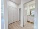 Hallway featuring closet and entry to bathroom with granite vanity and white cabinets at 118 3Rd Nw Ave, Conover, NC 28613
