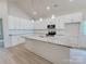 Modern kitchen with white cabinetry, granite countertops, and stainless steel appliances at 118 3Rd Nw Ave, Conover, NC 28613