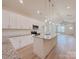Bright kitchen features granite countertops, white cabinets, and a central island and an open floor plan at 118 3Rd Nw Ave, Conover, NC 28613