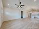 Large open-concept living area with ceiling fan, bright lighting, and neutral walls at 118 3Rd Nw Ave, Conover, NC 28613