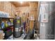 Utility room featuring water heater, HVAC system, and storage shelves at 1207 Skyflower Way, Charlotte, NC 28214