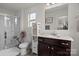 Bathroom featuring a glass door shower, wooden vanity with white countertop, and matching mirror at 1207 Skyflower Way, Charlotte, NC 28214