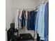Organized closet with hanging clothes, shelving, luggage, and storage solutions at 1207 Skyflower Way, Charlotte, NC 28214