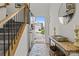 Bright entryway with an open door view, wood floors, stylish decor, and access to staircase at 1207 Skyflower Way, Charlotte, NC 28214
