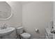 Small powder room featuring pedestal sink, toilet, and neutral wall color at 1207 Skyflower Way, Charlotte, NC 28214