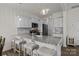 Modern kitchen featuring white cabinets, granite countertops, stainless steel appliances, and a breakfast bar at 1207 Skyflower Way, Charlotte, NC 28214