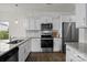Bright kitchen featuring white cabinets, granite countertops, stainless steel appliances, and hardwood floors at 1207 Skyflower Way, Charlotte, NC 28214