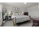 Spacious main bedroom featuring a metal bed frame, plush carpet, and an accent mirror at 1207 Skyflower Way, Charlotte, NC 28214