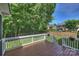 Well-maintained back deck with white railings and a view of the green, tree-filled backyard at 12644 Lahinch Ct, Charlotte, NC 28277