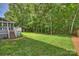 Lush green backyard with mature trees, offering a private and serene outdoor space at 12644 Lahinch Ct, Charlotte, NC 28277