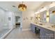 Bright and airy bathroom featuring walk-in shower, double vanity with gold accents, and modern fixtures at 12644 Lahinch Ct, Charlotte, NC 28277