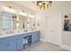 Modern primary bathroom featuring double vanity with gold accents, grey tile floors, and walk-in shower at 12644 Lahinch Ct, Charlotte, NC 28277