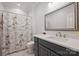 Bright bathroom with tiled shower and Paris themed shower curtain and decor at 12644 Lahinch Ct, Charlotte, NC 28277