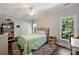 Bedroom with wood floors, gray rug, and large window with wooded exterior view at 12644 Lahinch Ct, Charlotte, NC 28277