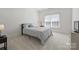 Minimal bedroom with carpet, queen bed, and bright window with natural light at 12644 Lahinch Ct, Charlotte, NC 28277
