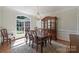 Formal dining room featuring hardwood floors, wainscoting, and a large window for natural light at 12644 Lahinch Ct, Charlotte, NC 28277