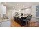 Kitchen features a large island, stainless steel appliances, granite counters, and white cabinetry at 12644 Lahinch Ct, Charlotte, NC 28277