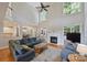Open-concept living room with tall ceilings, a fireplace, and large windows that flood the room with natural light at 12644 Lahinch Ct, Charlotte, NC 28277