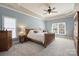 Bright main bedroom with vaulted ceiling, ceiling fan, and natural light from large windows at 12644 Lahinch Ct, Charlotte, NC 28277