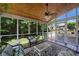 Charming screened porch with wood ceiling and inviting seating; ideal for enjoying the outdoors at 12644 Lahinch Ct, Charlotte, NC 28277