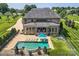 Stunning aerial view of a home with a pool, lounge chairs, outdoor seating, and lush landscaping at 14041 Mccord Rd, Huntersville, NC 28078