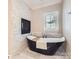 Elegant bathroom with freestanding tub, fireplace, and accent wall at 14041 Mccord Rd, Huntersville, NC 28078