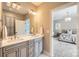 Bright bathroom with double vanity, stylish hardware, and open doorway to the bedroom at 14041 Mccord Rd, Huntersville, NC 28078