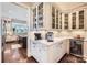 Butler's pantry with glass-front cabinets, beverage cooler, and counter space, adding convenience and style at 14041 Mccord Rd, Huntersville, NC 28078