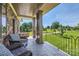 Covered porch with stone columns overlooking manicured lawn and lush landscaping at 14041 Mccord Rd, Huntersville, NC 28078