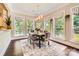 Bright dining room featuring large windows, hardwood floors, and stylish decor at 14041 Mccord Rd, Huntersville, NC 28078