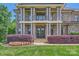 A detailed view of the home's entrance, highlighting the stone facade, columns, and landscaped flowerbeds at 14041 Mccord Rd, Huntersville, NC 28078