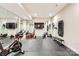 Home gym with mirrored walls, mounted TV, rubber floor, and fitness equipment at 14041 Mccord Rd, Huntersville, NC 28078