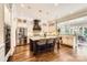 Open-concept kitchen with a large island, stainless steel appliances, and hardwood floors, ideal for modern living at 14041 Mccord Rd, Huntersville, NC 28078