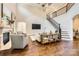 Spacious living room featuring hardwood floors, a fireplace, and an open staircase at 14041 Mccord Rd, Huntersville, NC 28078
