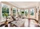 Sun-drenched sunroom with large windows offering backyard views, perfect for relaxation at 14041 Mccord Rd, Huntersville, NC 28078